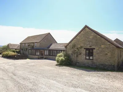 a large stone house with a gravel driveway at Finest Retreats - The Walton in Onibury