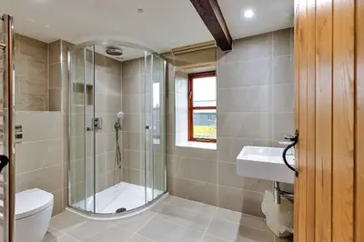 a bathroom with a shower and a toilet and a sink at Finest Retreats - The Walton in Onibury