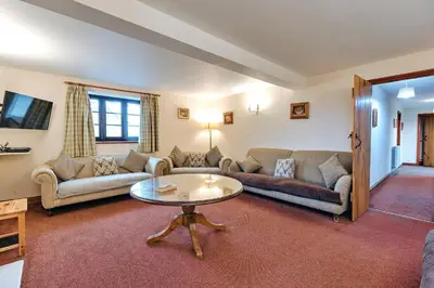 a living room with a couch and a table at Finest Retreats - The Walton in Onibury