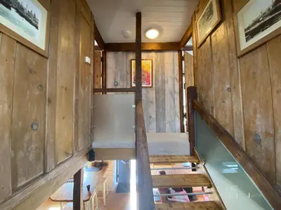 an inside view of a tiny house with a staircase at No 2 Dolheulog Aberaeron in Aberaeron