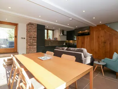 a living room with a table and a couch at Barn Cottage in Leominster