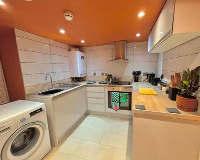 a kitchen with a washing machine and a sink at Brecon serviced apartments- Kian Perrott Properties in Brecon