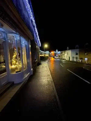 a train traveling down a street at night at Beech Cottage with Clun Castle View in Clun