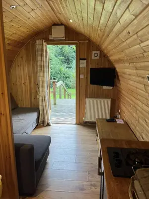 a small room with a bed and a tv in a room at Mountain Edge Resort Mega pod 5 with Hot Tub in Church Stretton