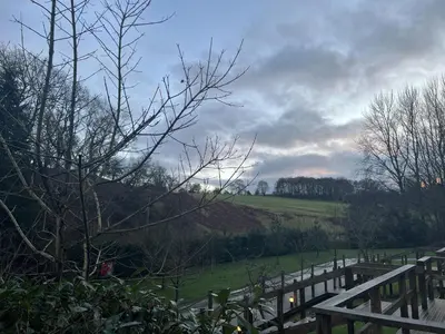 a wooden fence with a field in the background at Mountain Edge Resort Mega pod 6 with Hot Tub in Church Stretton