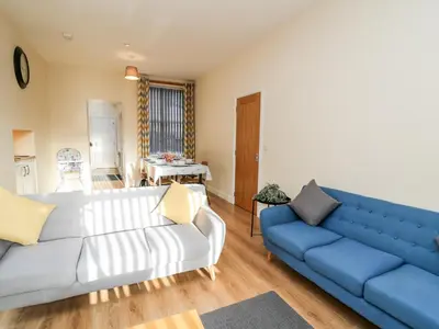a living room with a couch and a blue sofa at Afonwy House in Rhayader