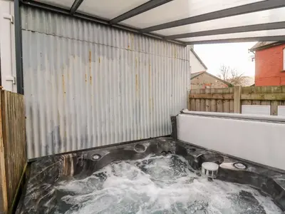 a hot tub in the back of a building at Afonwy House in Rhayader