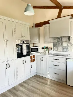 a white kitchen with white cabinets and appliances at Leverets - Squirrel Lane Lodges Ludlow in Ludlow