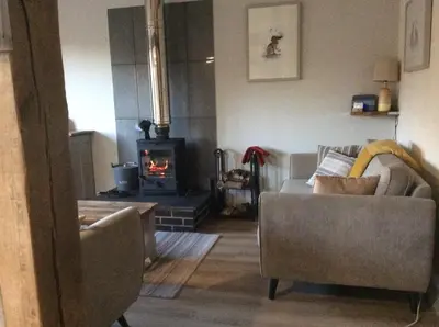 a living room with a couch and a fireplace at Leverets - Squirrel Lane Lodges Ludlow in Ludlow