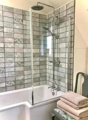 a bathroom with a shower and a bath tub at The Nut House - Squirrel Lane Lodges Ludlow in Ludlow