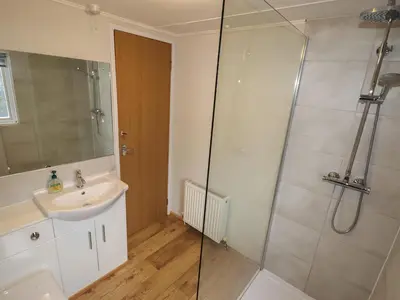 a bathroom with a sink and a shower at Wayside Lodge in Craven Arms