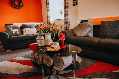 a living room with a coffee table and a couch at Luxury 5-Bed Farmhouse - Sleeps 8 & Hot Tub in Brecon