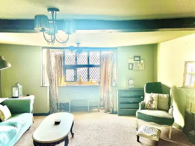 a living room with a couch and a table at Little Libertys in Shrewsbury
