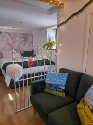a living room with a couch and a bed at The Walkers' Cwtch in Ffestiniog