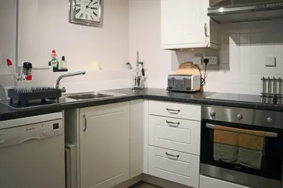 a kitchen with a sink and a counter top at Aragon Cottage in Ludlow