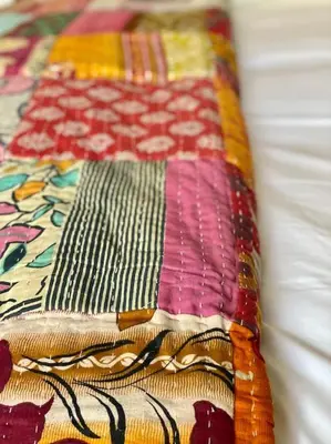 a close up of a quilt on a bed at Aragon Cottage in Ludlow