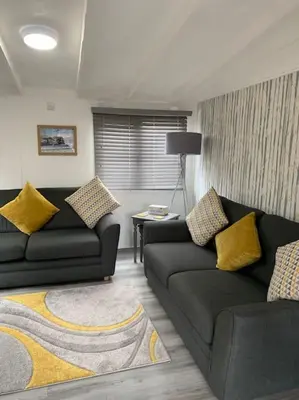 a living room with two couches and a table at Lakeside retreat - Lodge 2F caer beris holiday park - no commercial vehicles allowed on site in Builth Wells