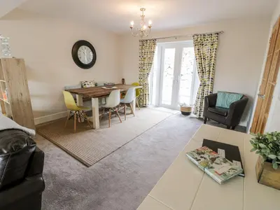 a living room with a table and chairs at Ty Ni in Dyffryn
