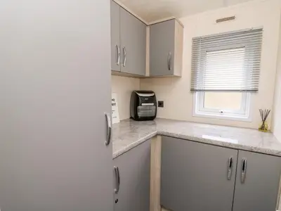 a kitchen with a counter top with a microwave at The Hideout in Llanina