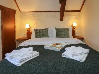 a hotel room with a bed with towels on it at Y Cartws in Llanybydder