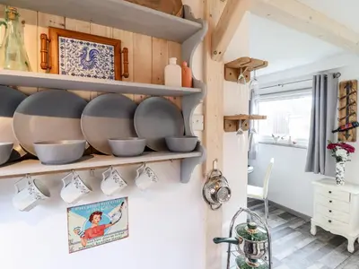 a kitchen with plates on shelves on the wall at Chalet Forte in Aberdyfi