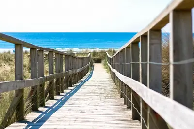 a wooden bridge leading to the beach at Ty-Gwair-Byrdir in Dyffryn