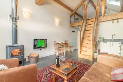 a living room with a fireplace and a stove at Nant in Dyffryn