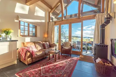 a living room with a couch and a fireplace at Nant in Dyffryn