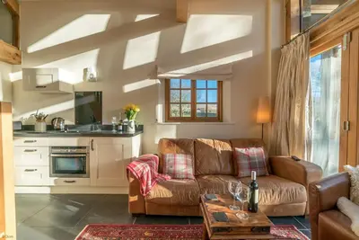 a living room with a couch and a table at Nant in Dyffryn