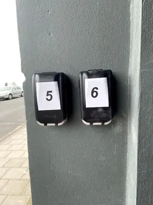 two clocks on a wall with the number six at Maisonette flat Aberystwyth in Aberystwyth