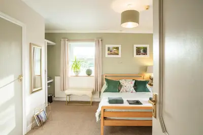 a bedroom with a bed and a window at The Cedars in Builth Wells
