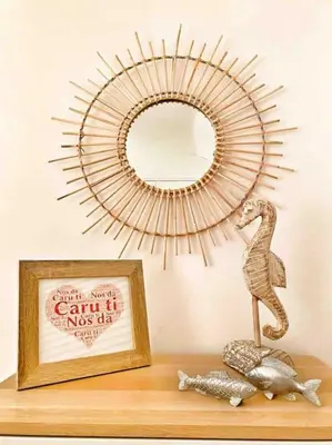 a mirror on a shelf next to a picture and a statue at Cosy Cottage in Aberaeron