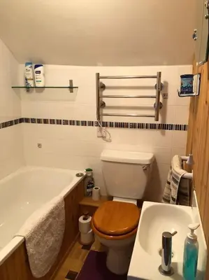 a bathroom with a toilet and a tub and a sink at Lavender Cottage, 3 School Road, Clun, Shropshire in Clun