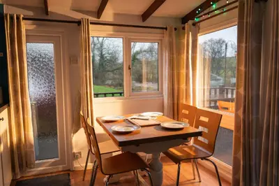 a table and chairs in a room with a window at Bunny Lodge 30 - Riverside in Builth Wells
