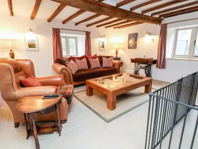 a living room with a couch and a coffee table at Rockhill Farmhouse in Craven Arms