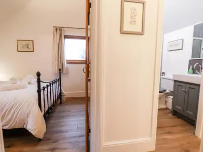 a bedroom with a bed and a sink at Rockhill Farm Hay Barn in Craven Arms