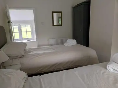 a bedroom with two beds with towels on them at Afonfa - Llanuwchllyn in Bala