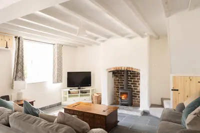 a living room with a couch and a fireplace at Afonfa - Llanuwchllyn in Bala