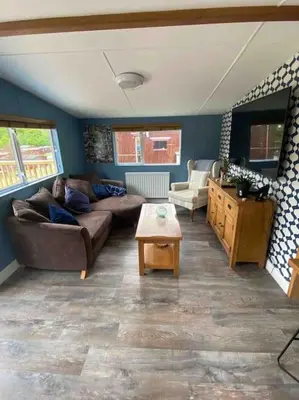 a living room with a couch and a table at The Cherries - Caer beris holiday park 2 bedroom lodge - No commercial vehicles allowed on site in Builth Wells