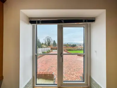 a sliding glass door with a view of a patio at The Annexe in Guilsfield