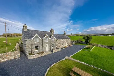 an old stone house in a field of grass at Ty-Newydd-Frongaled in Dyffryn