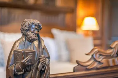a bronze statue of a man holding a book at Gors-Y-Gedol in Dyffryn