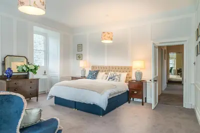a bedroom with a bed and two lamps and a chair at Gors-Y-Gedol in Dyffryn