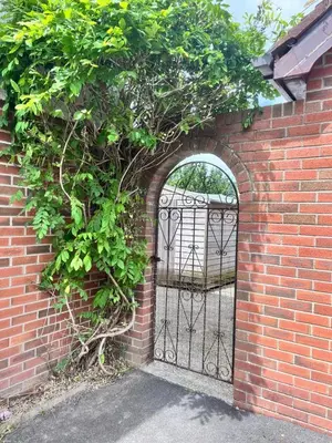 an entrance to a brick wall with an iron gate at King room - PenrhynCoch - Aberystwyth in Aberystwyth
