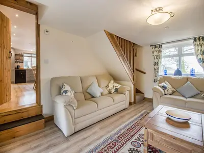 a living room with a couch and a table at Frondeg Bach in Cross Inn