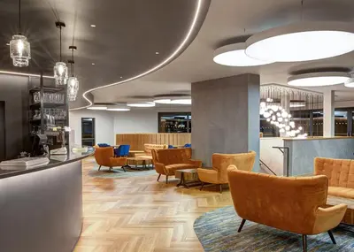a lobby with chairs and tables and a bar at Aber Bay Holiday Park in Aberystwyth