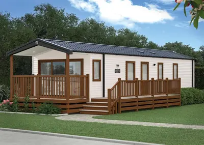 a tiny house with a porch and a deck at Aber Bay Holiday Park in Aberystwyth