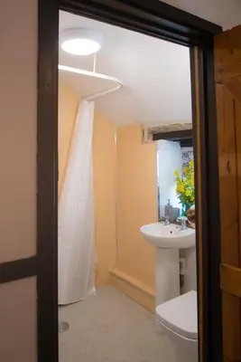 a bathroom with a toilet and a sink at Tan Y Bryn in Llanrhystyd