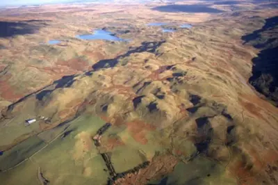 an aerial view of a desert field with water at Yr Hen Efail - Old Smithy in Tregaron