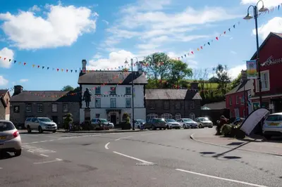 a town street with cars parked on the road at Yr Hen Efail - Old Smithy in Tregaron